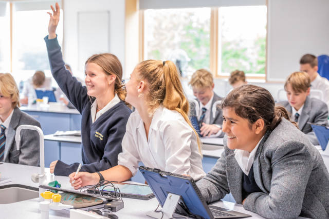 Ardingly College - Pupil raises hand during science lesson.