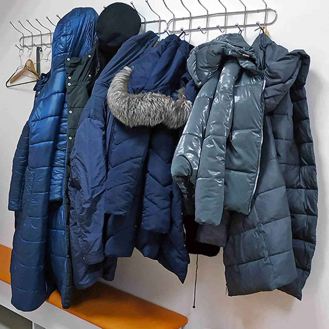 A coat rack of winter jackets.