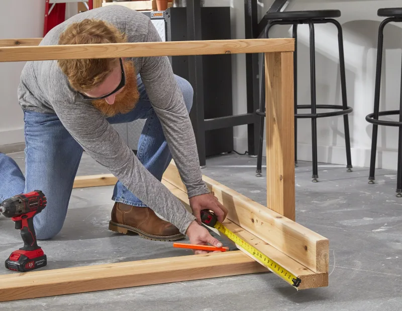 A man measuring the planks 