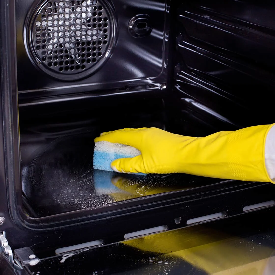 Someone cleans an oven