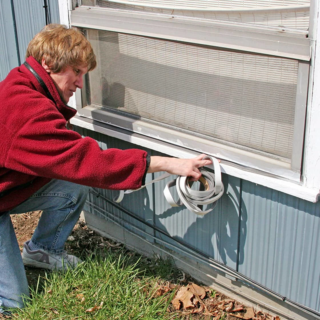 Someone seals a window