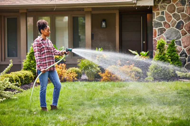 Woman watering her lawn