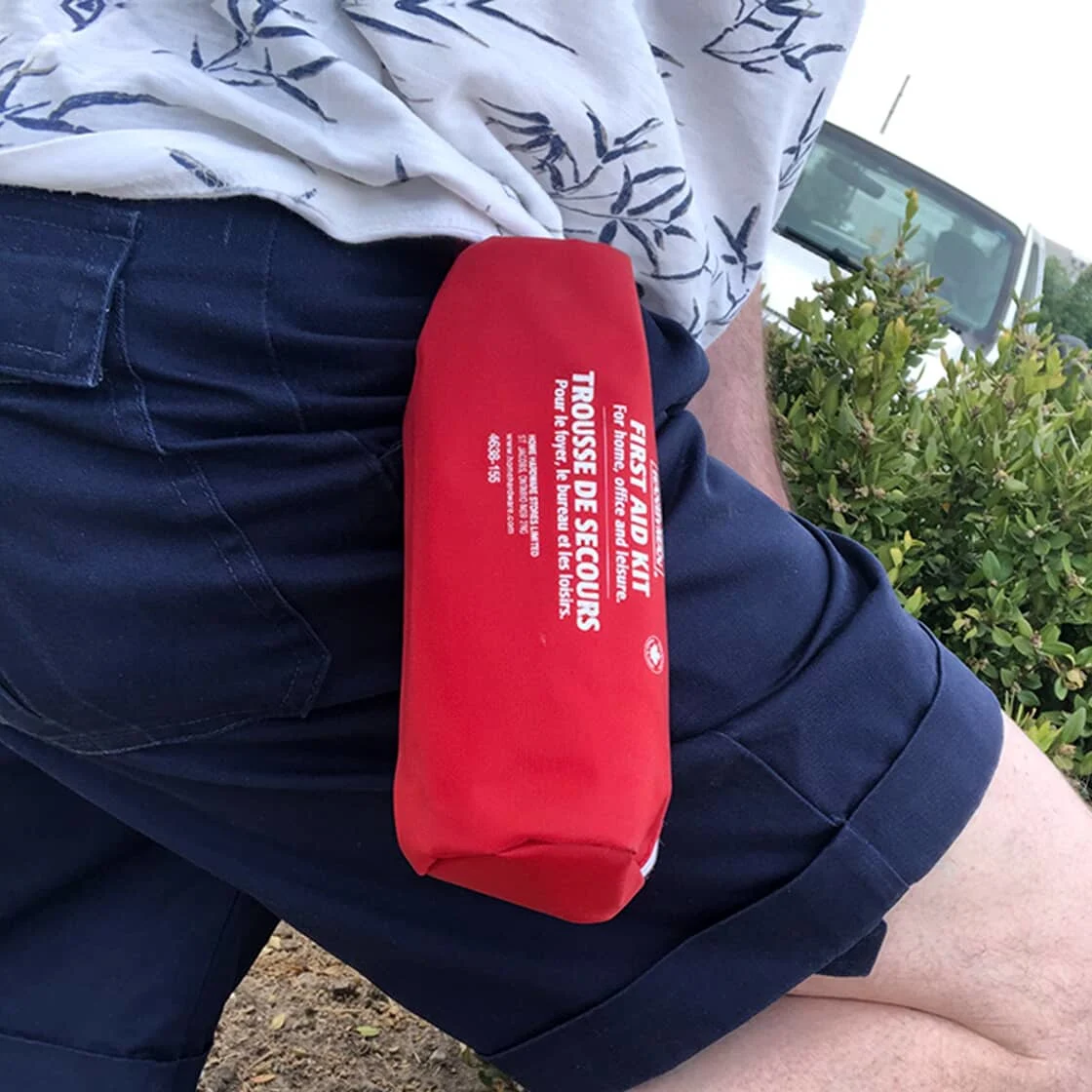 Someone wears a first aid kit.