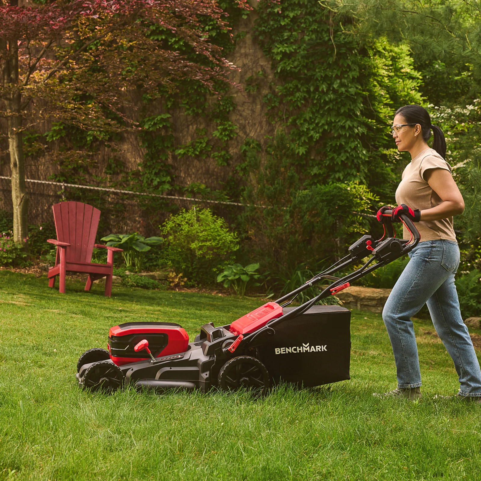 Woman mowing fall lawn