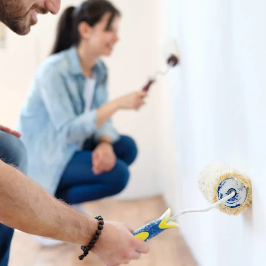 couple painting a wall