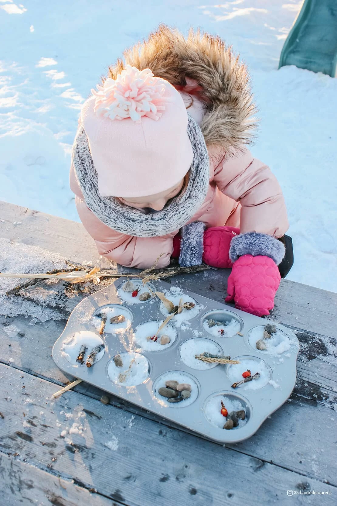 A child plays in the snow.