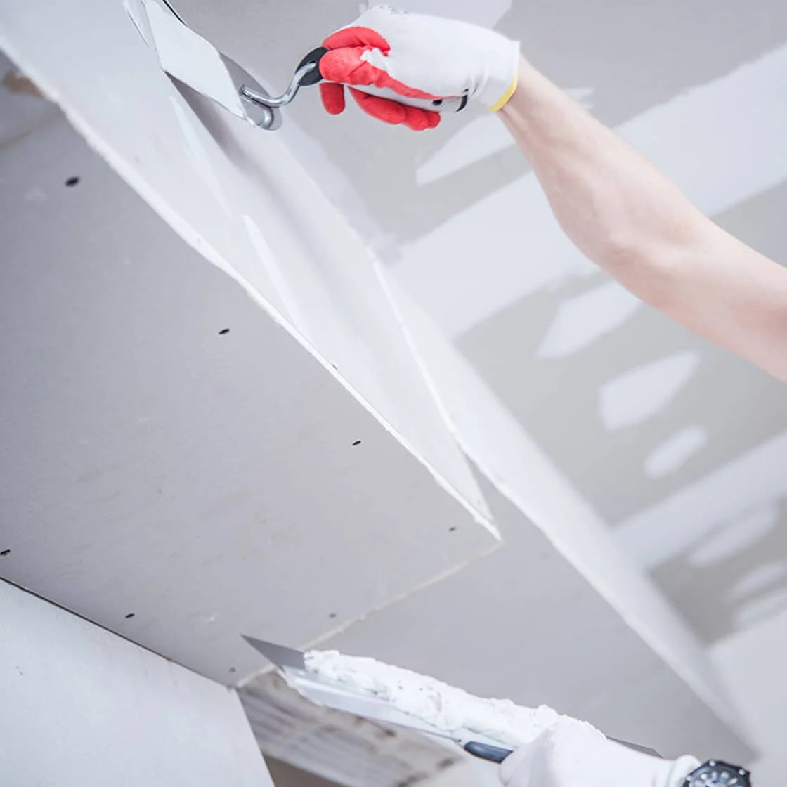 Person patching unpatched drywall