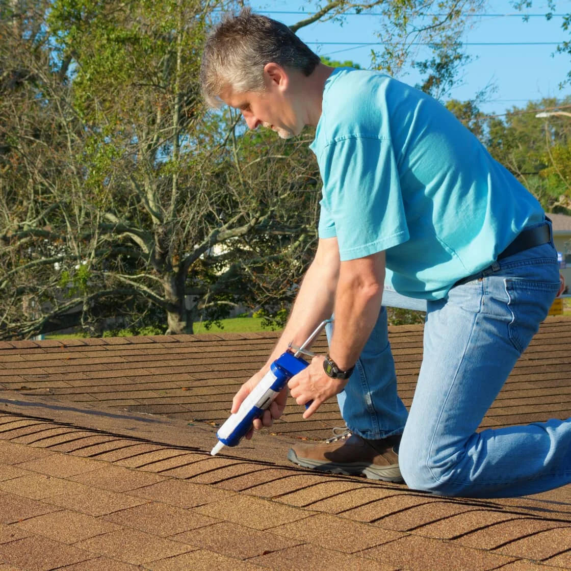 Someone repairs the roof