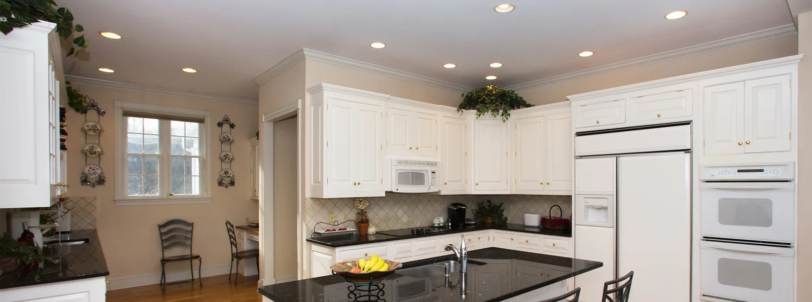 A kitchen with recessed lights