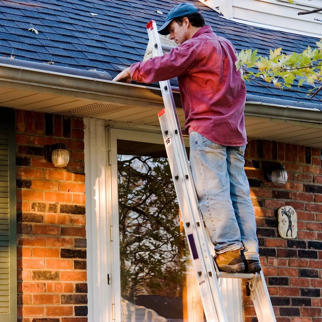 Someone cleans the gutters