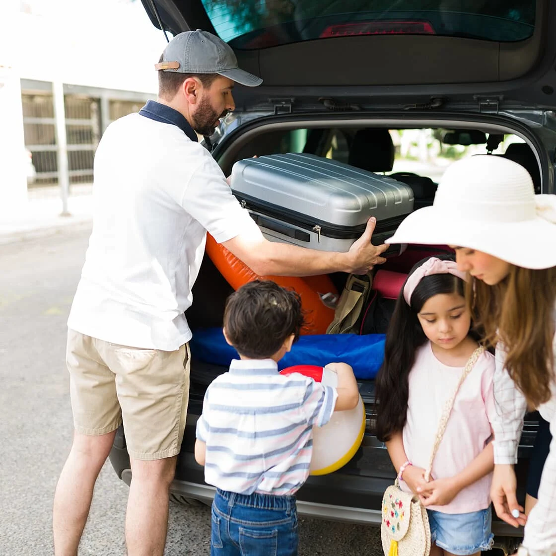 A family packs their car for the cottage.