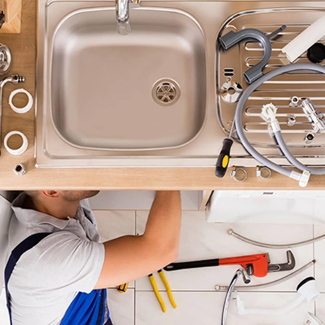 Someone fixing a kitchen sink