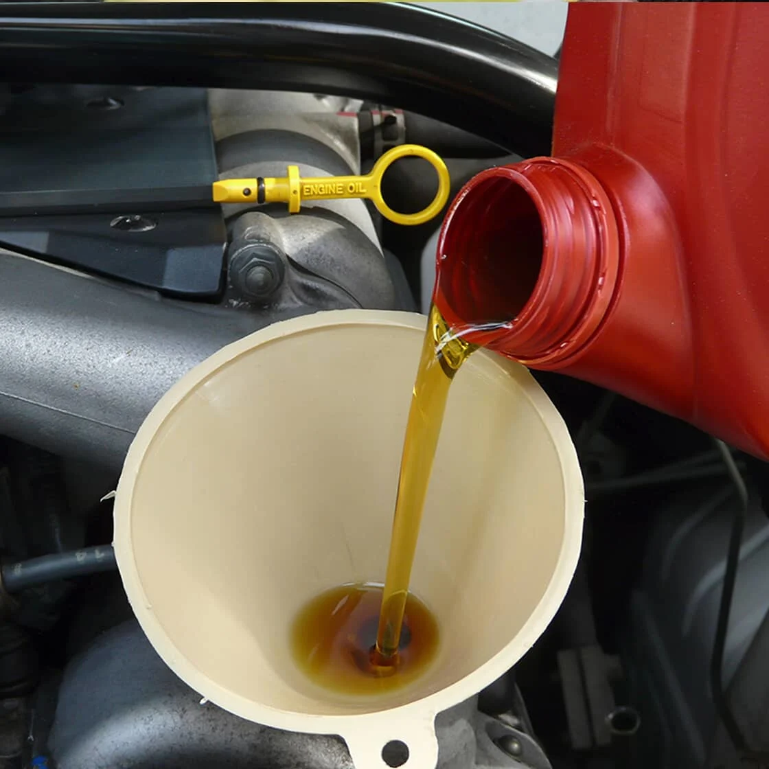 Someone pours engine oil