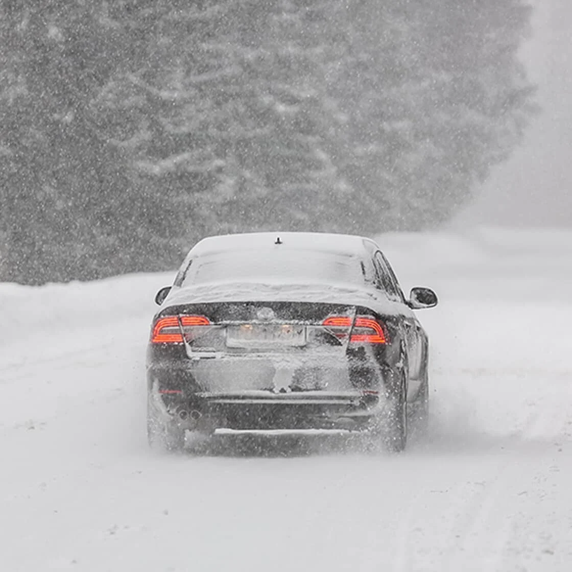 A car drives through the snow