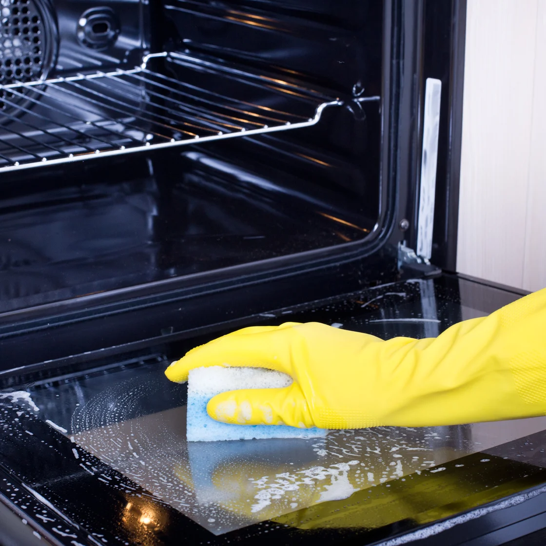 Someone cleans an oven