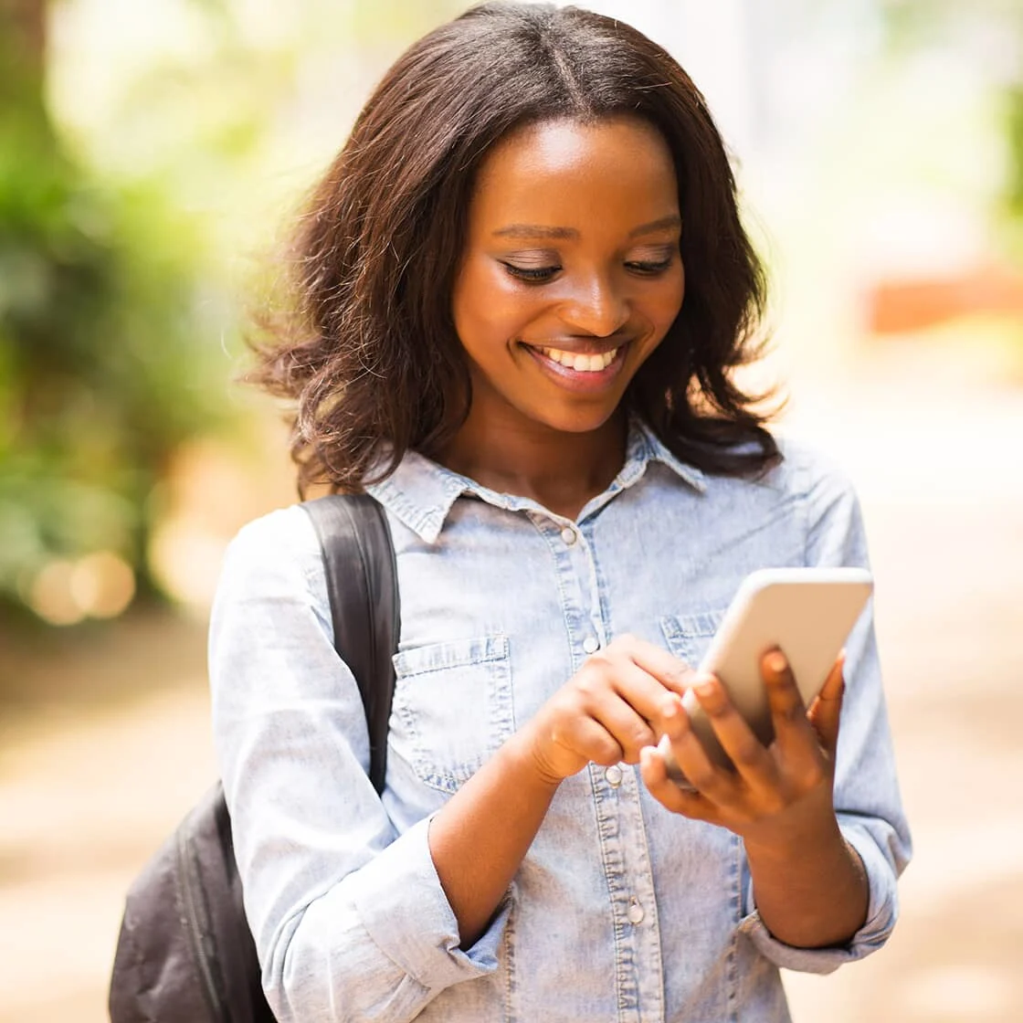 Image of a young woman checking her cellphone. 