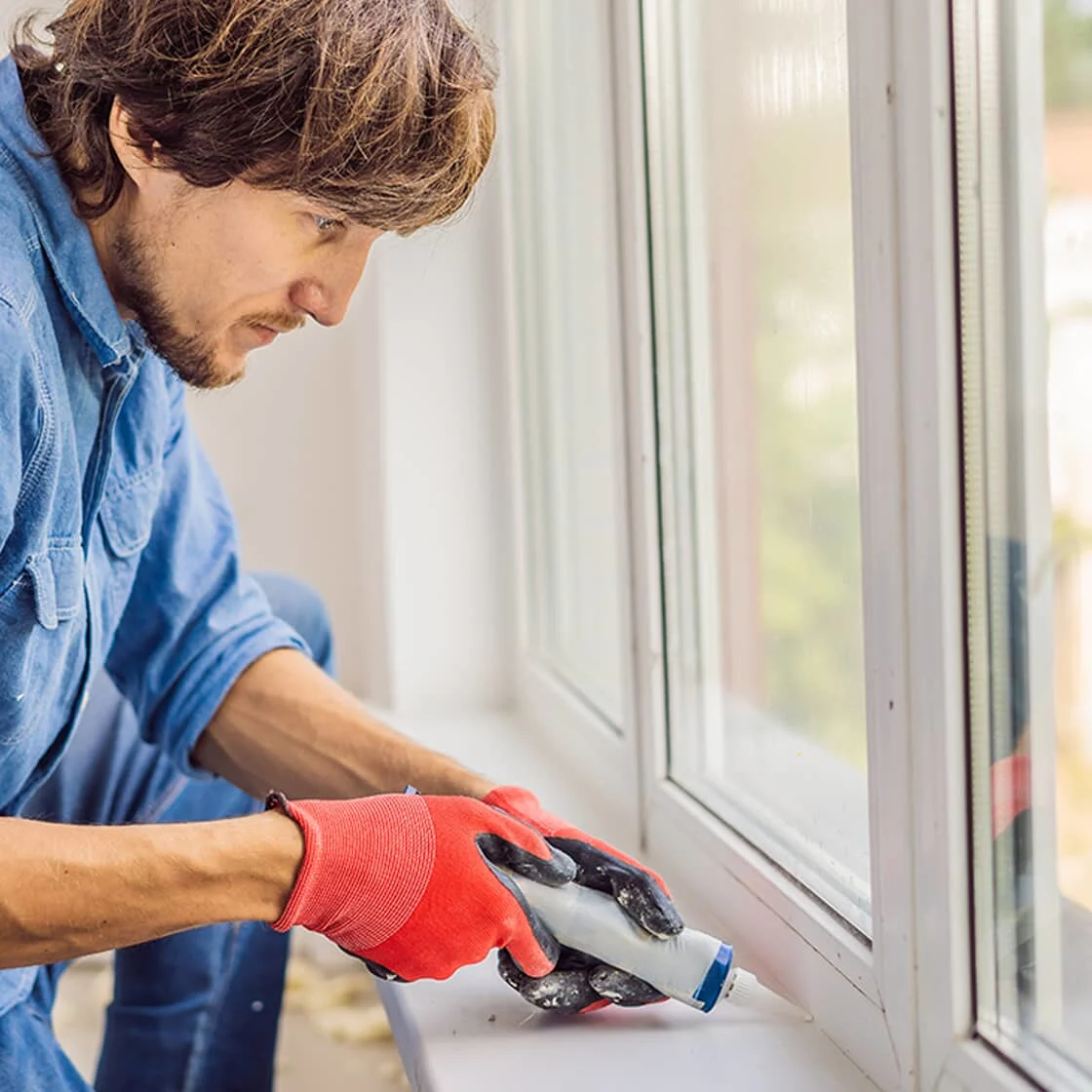Someone seals a window 