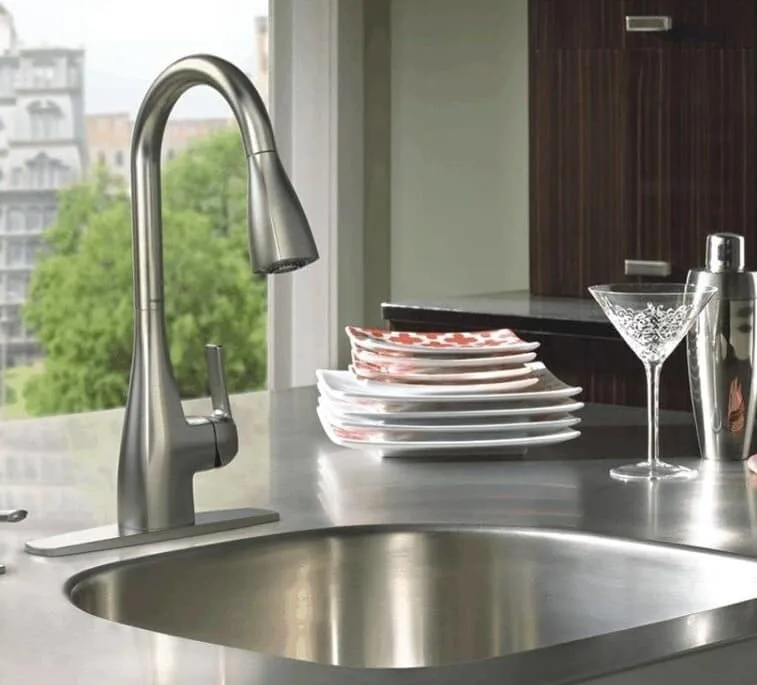 Single-handle kitchen faucet with martini glass next to sink