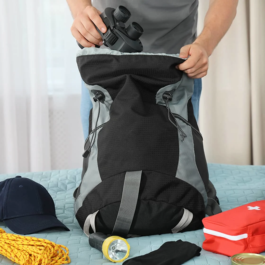 Someone packs a backpack.