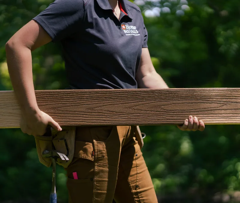 Home Hardware Employee carrying slat of wood