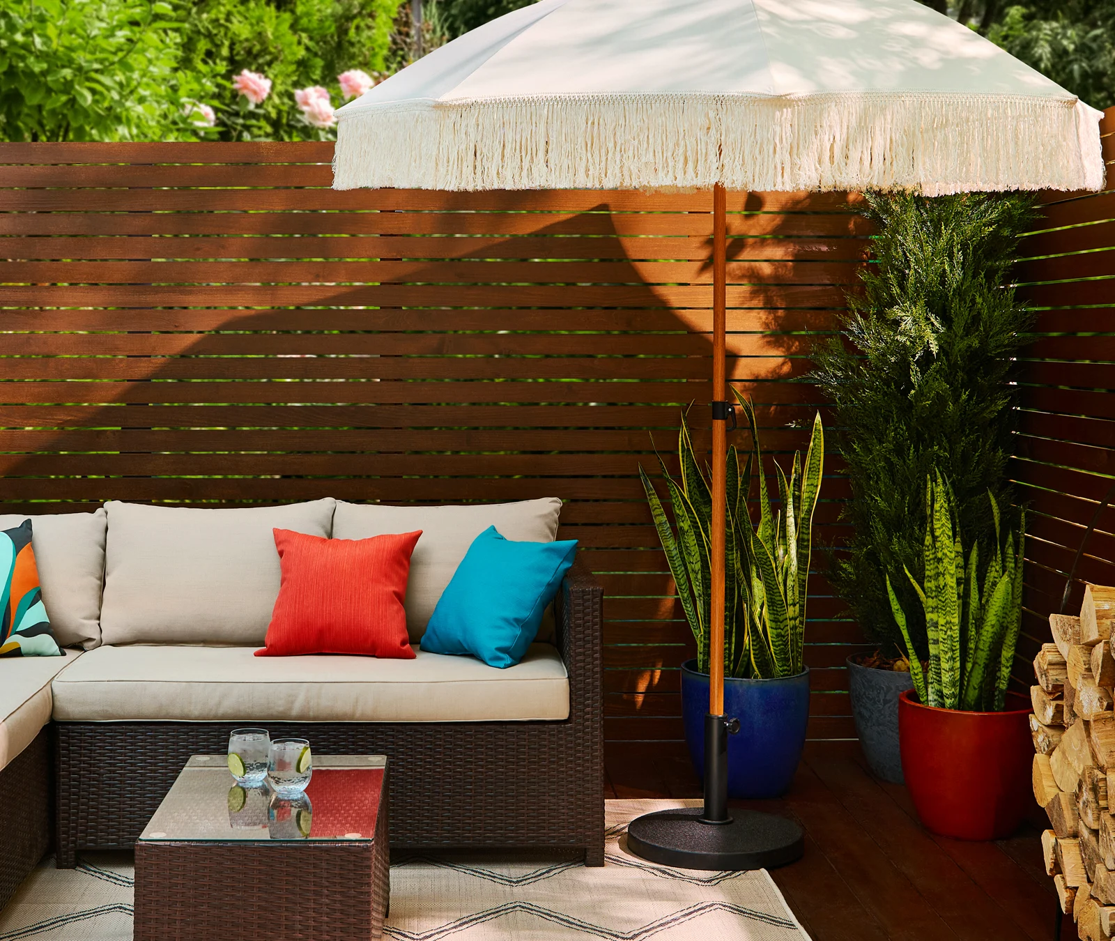 Wicker or rattan patio set with decor and pillows. 