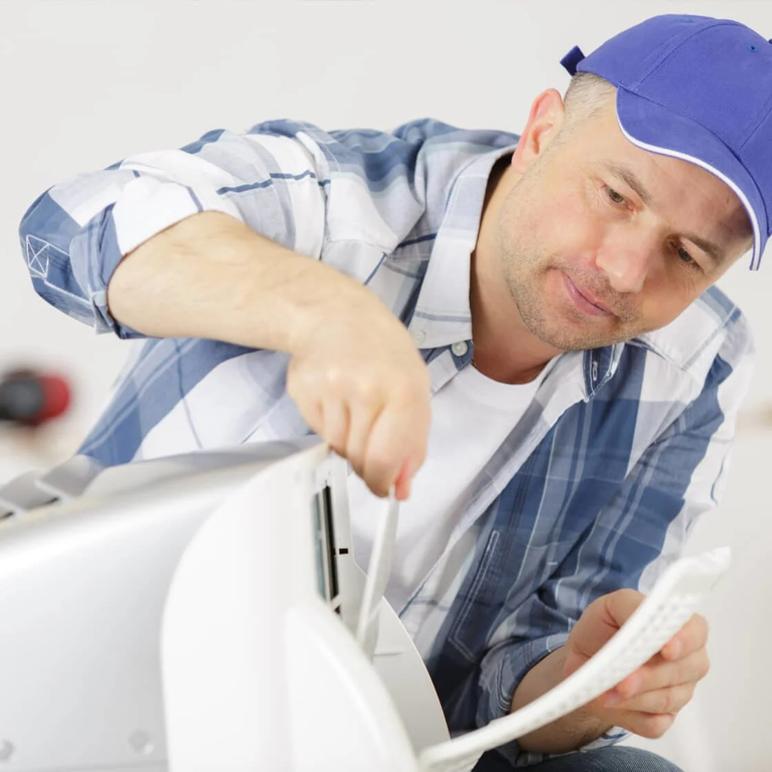 Repair person inspecting AC