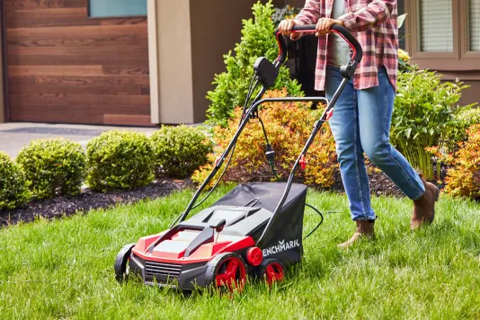 A homeowner mowing the lawn