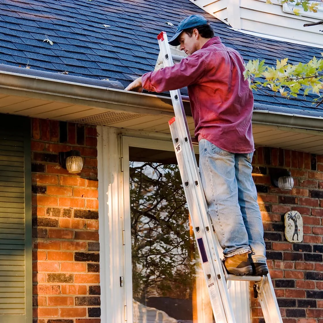 Someone cleans the gutters.