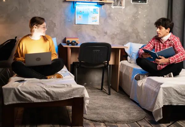 Two students in a small dorm room