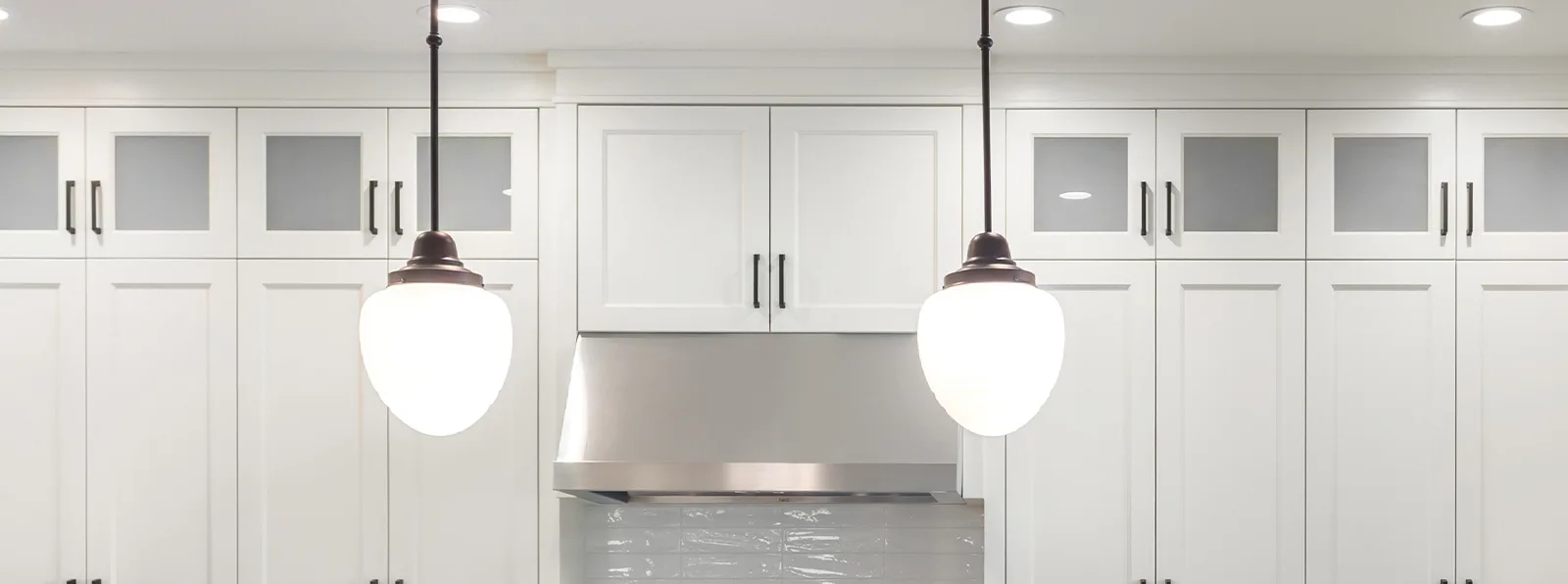 A kitchen with pendant lights 