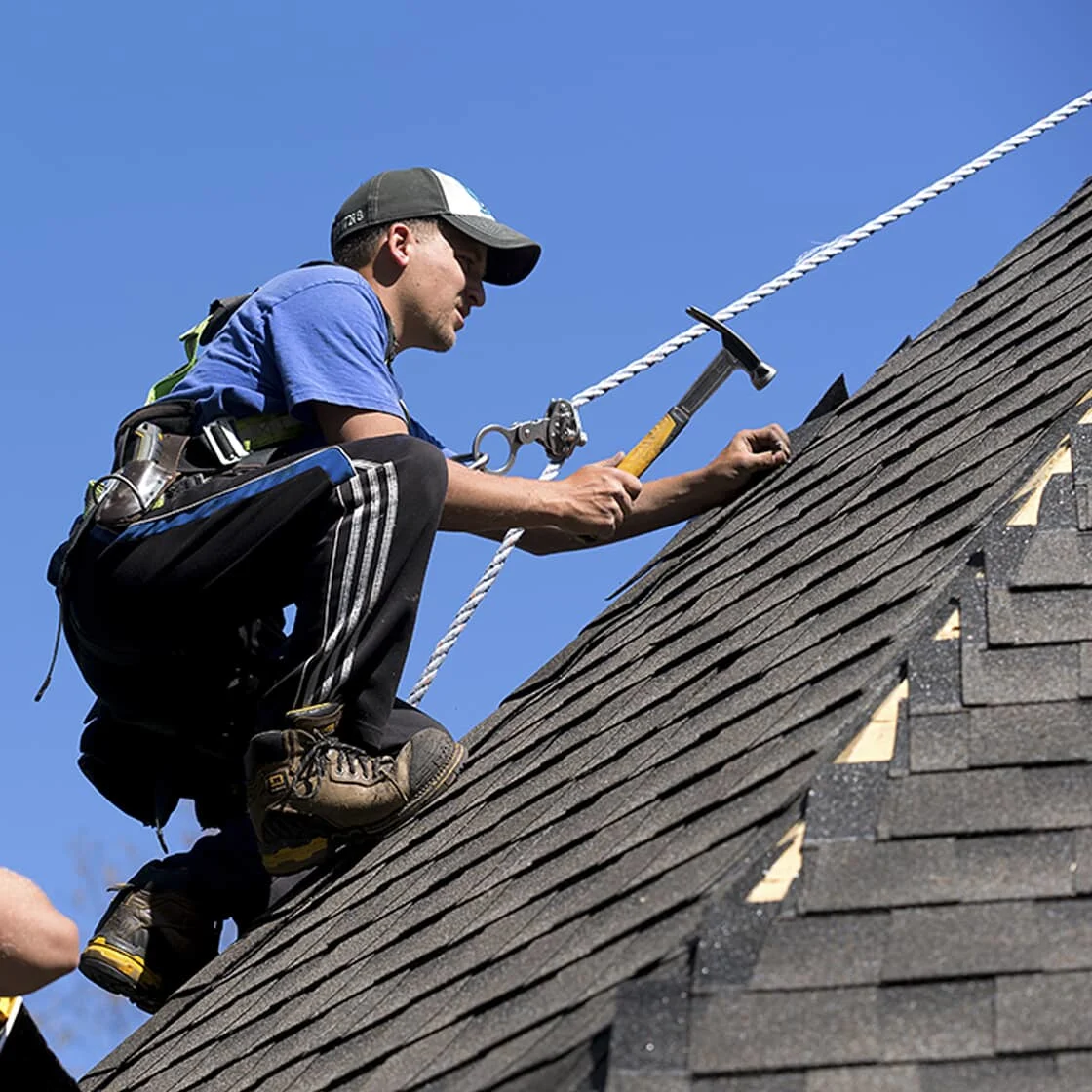 Someone repairs the roof