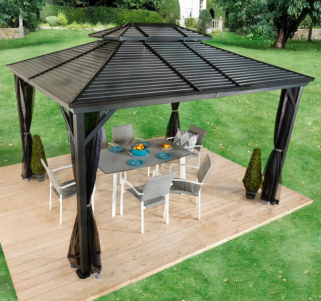 A gazebo and a dining set in a backyard.