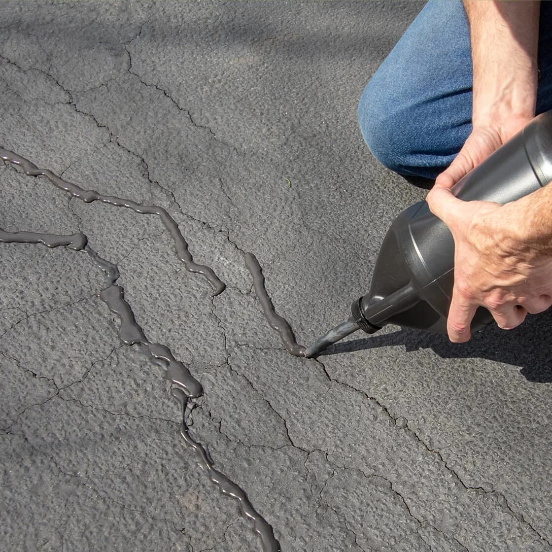Someone repairs driveway
