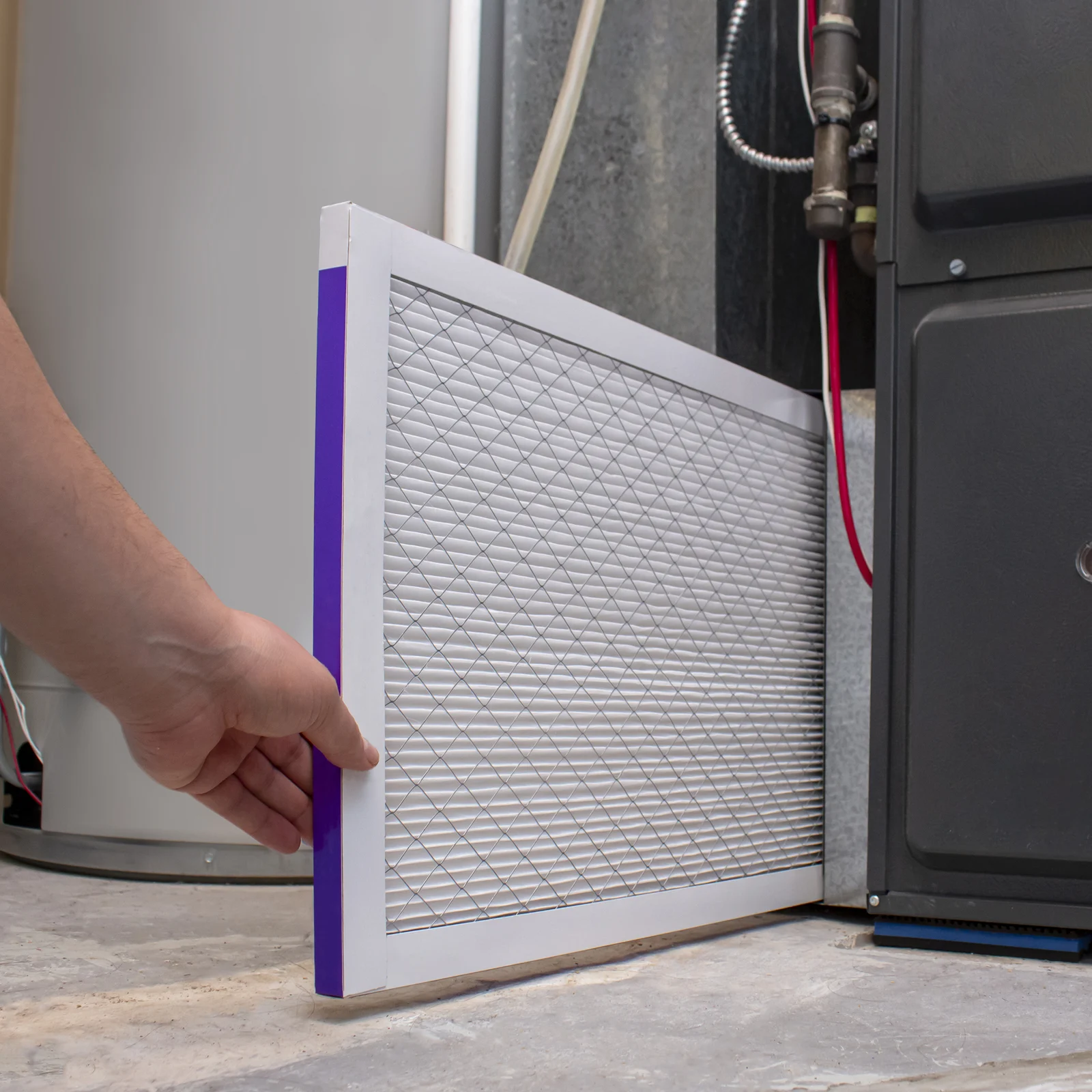 Man changing a furnace filter
