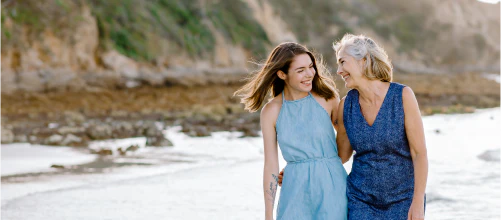 Two women walking in the sea