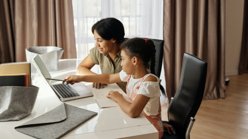 parent-helping-child-with-online-learning