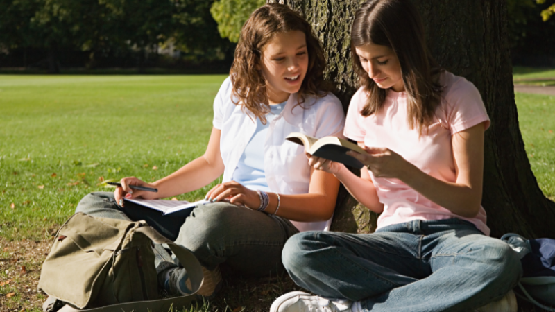 two-girls-studying-outdoors
