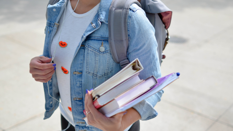 Female-student-carrying-books 