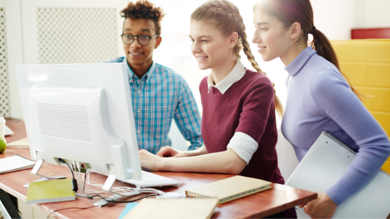 three-students-sat-at-computer