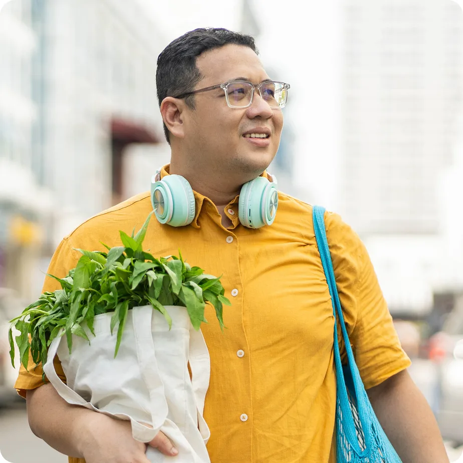 Man walking on street with groceries