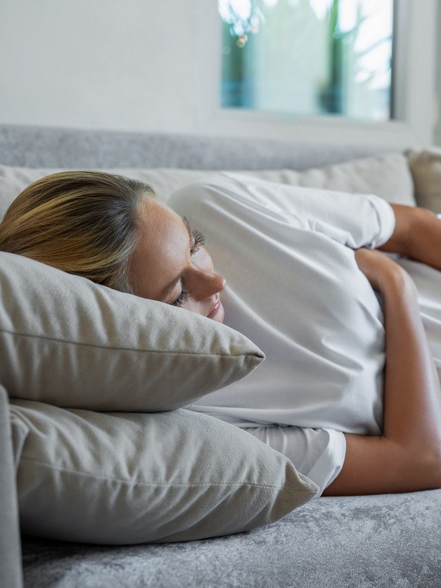 Pregnant woman resting on couch