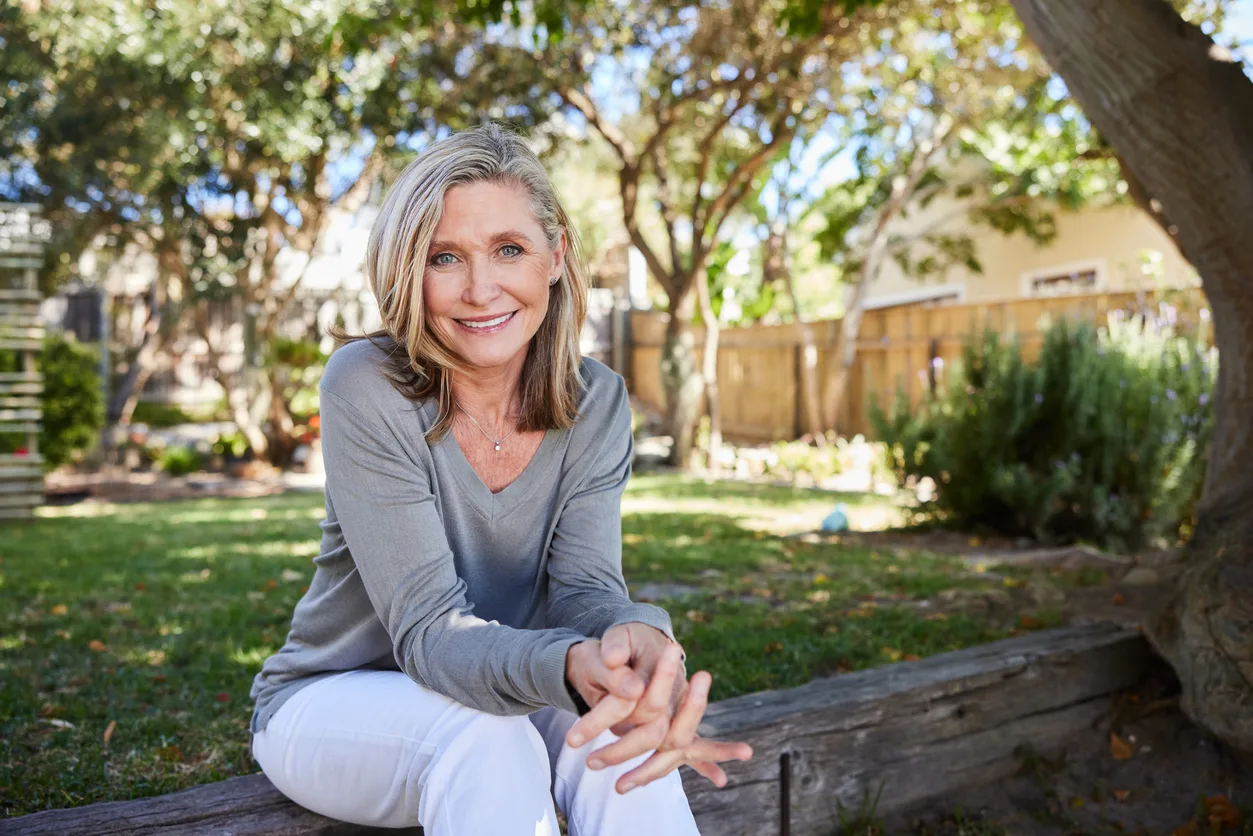 A sitting, smiling woman