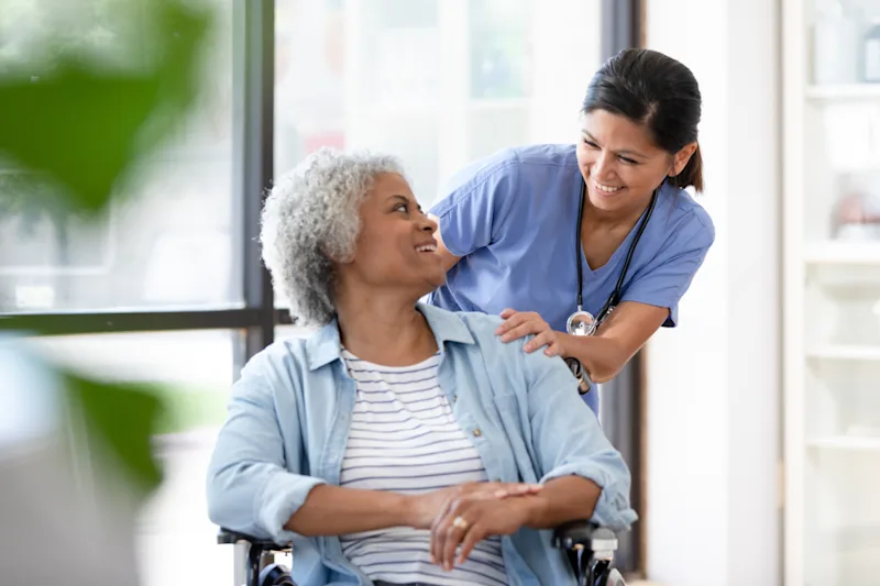 Doctor Helping Patient in Wheelchair