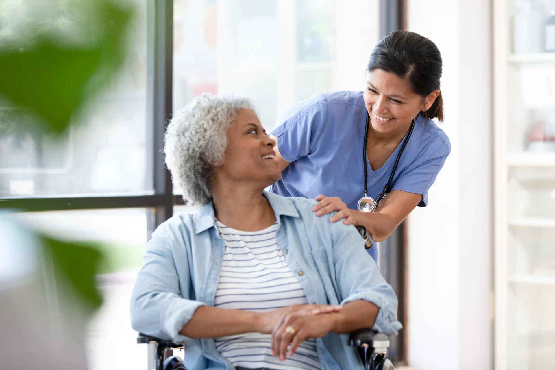 Doctor Helping Patient in Wheelchair