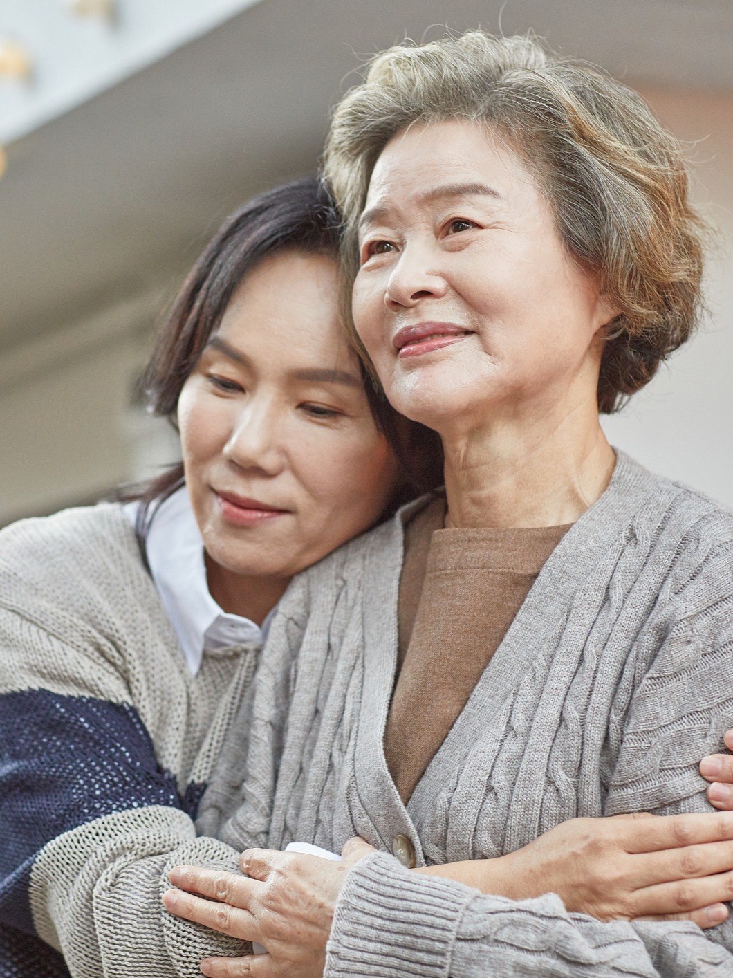 Woman hugging her elderly relative