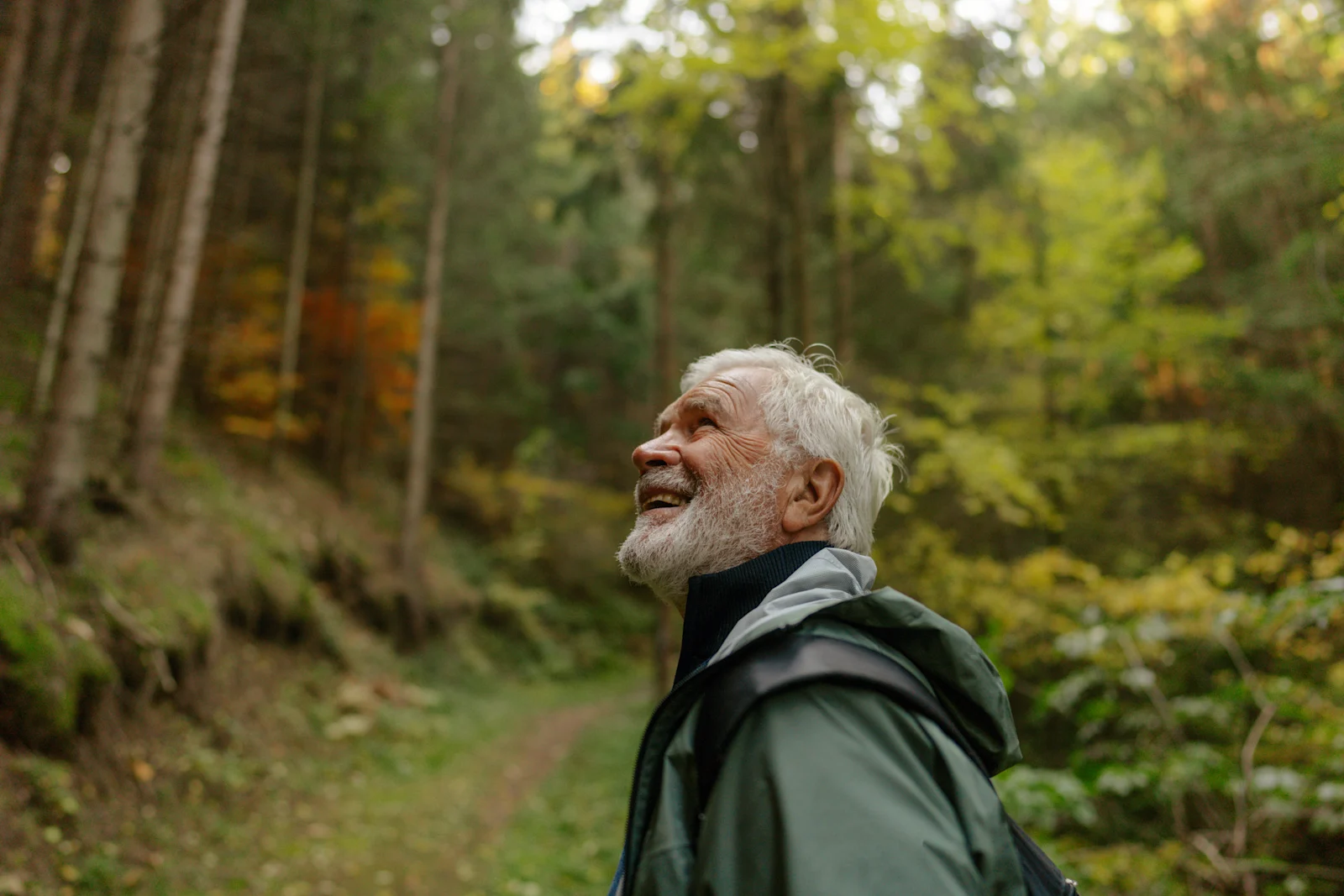 Older man enjoying nature in very green background