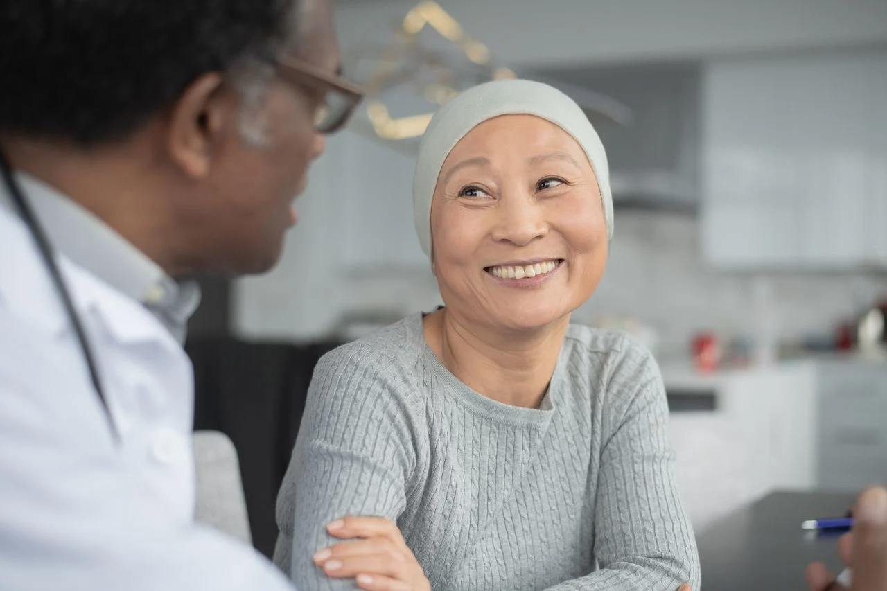 Woman with cancer smiling at her doctor