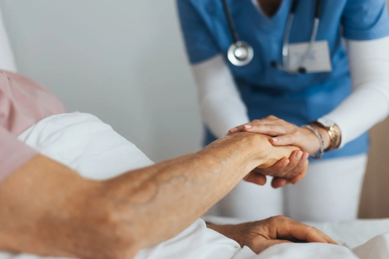 Woman holding nurse's hand