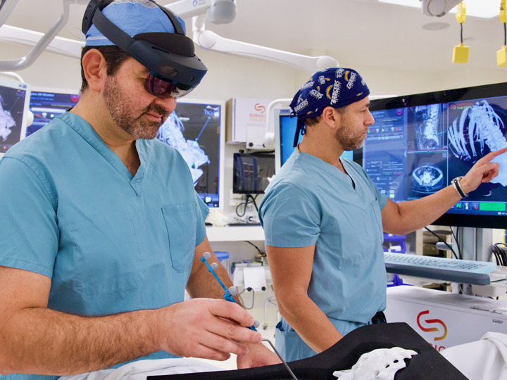 Hoag's top spinal surgeons, Burak Ozgur and Adam Kanter, use SyncAR to help with surgery