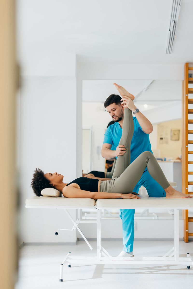 A physical therapist is helping a woman with her pelvic floor condition